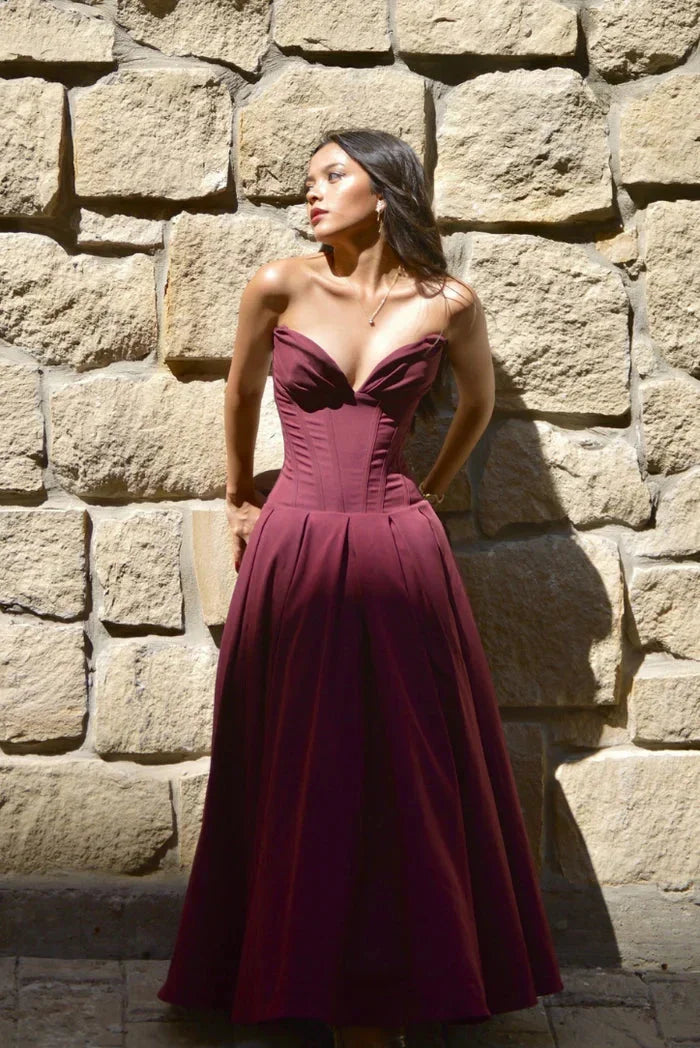Wine Red Kirra strapless corseted A-line midi dress with a structured design and flattering silhouette perfect for formal…