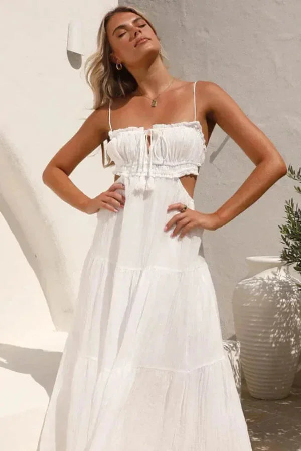 White tiered maxi dress with flowing skirt and a sleeveless design. Made from soft, breezy fabric for a comfortable and…