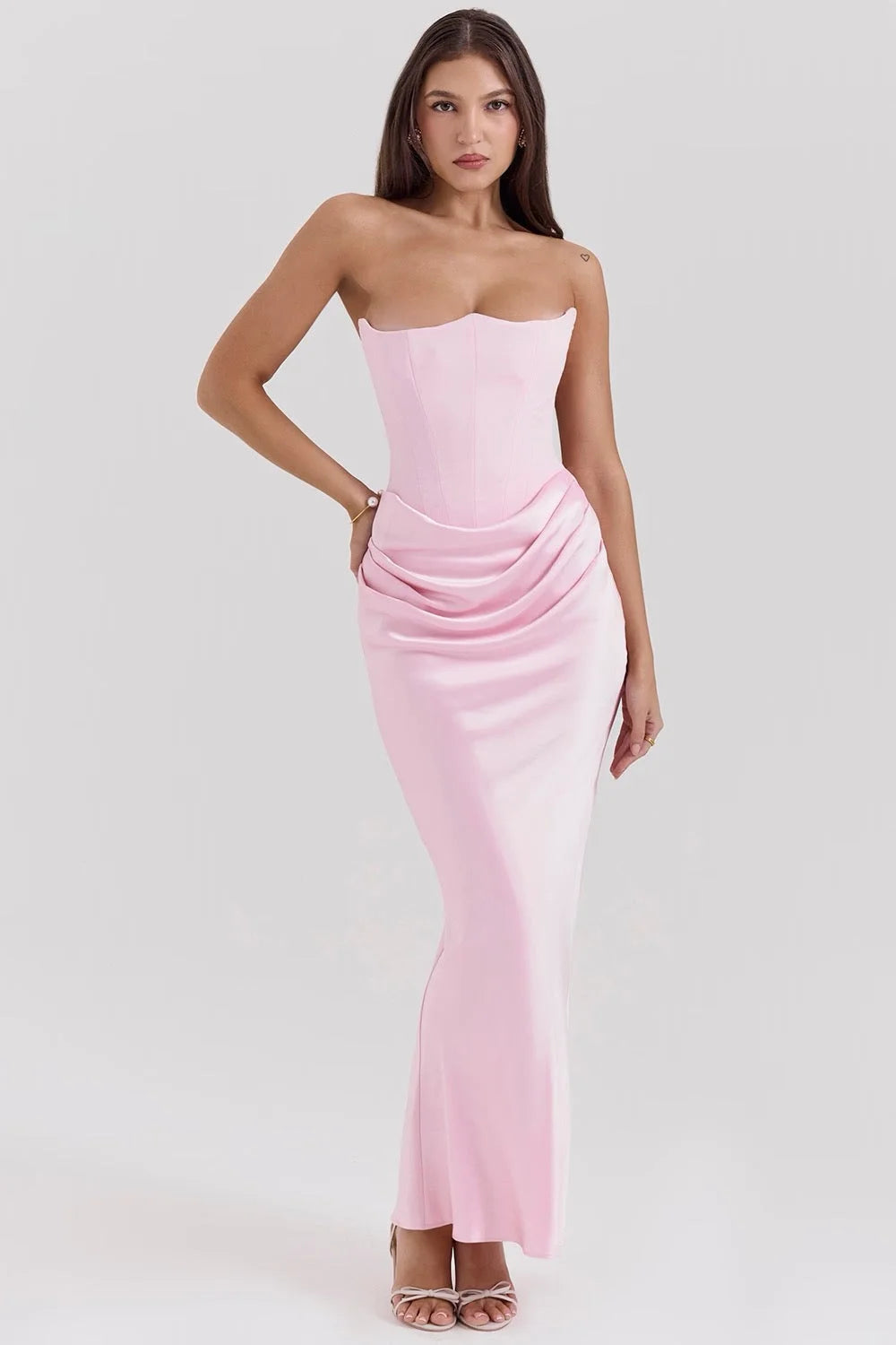 Strapless silk maxi dress in soft pink hue, featuring a flowing design perfect for special occasions.