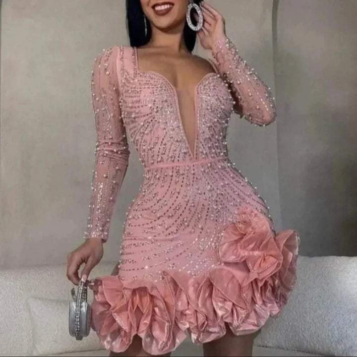 "Black mini dress with ruffles, sequin embellishments, and sheer mesh sleeves, perfect for special occasions."
