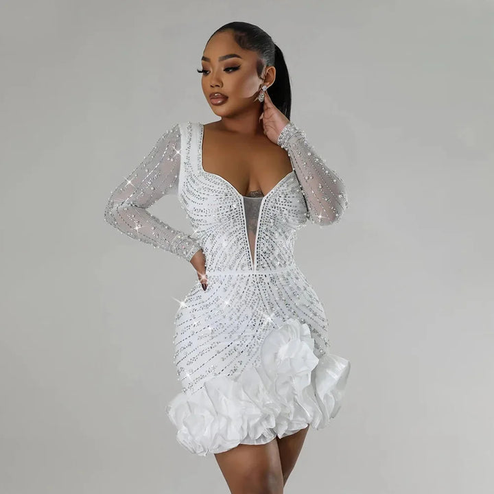 White mini dress with ruffles and embellishments by Klover. Lightweight material with intricate details.