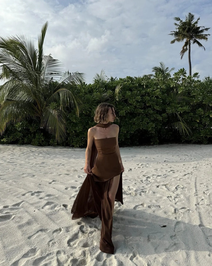 "Kori maxi dress in black, asymmetrical layers, sleeveless design, and soft flowy fabric."