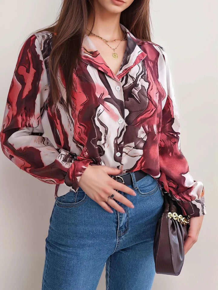 Burgundy satin top with artistic design, button-up front, effortlessly chic and stylish look.