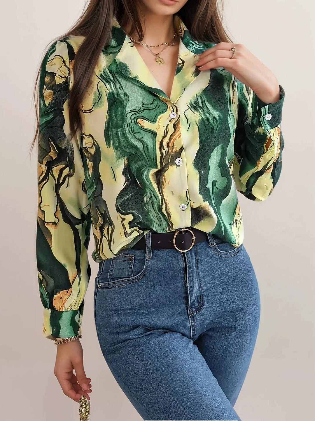 Green satin top with unique button-front design. Subtle sheen and artistic style make it a standout piece for any occasion.