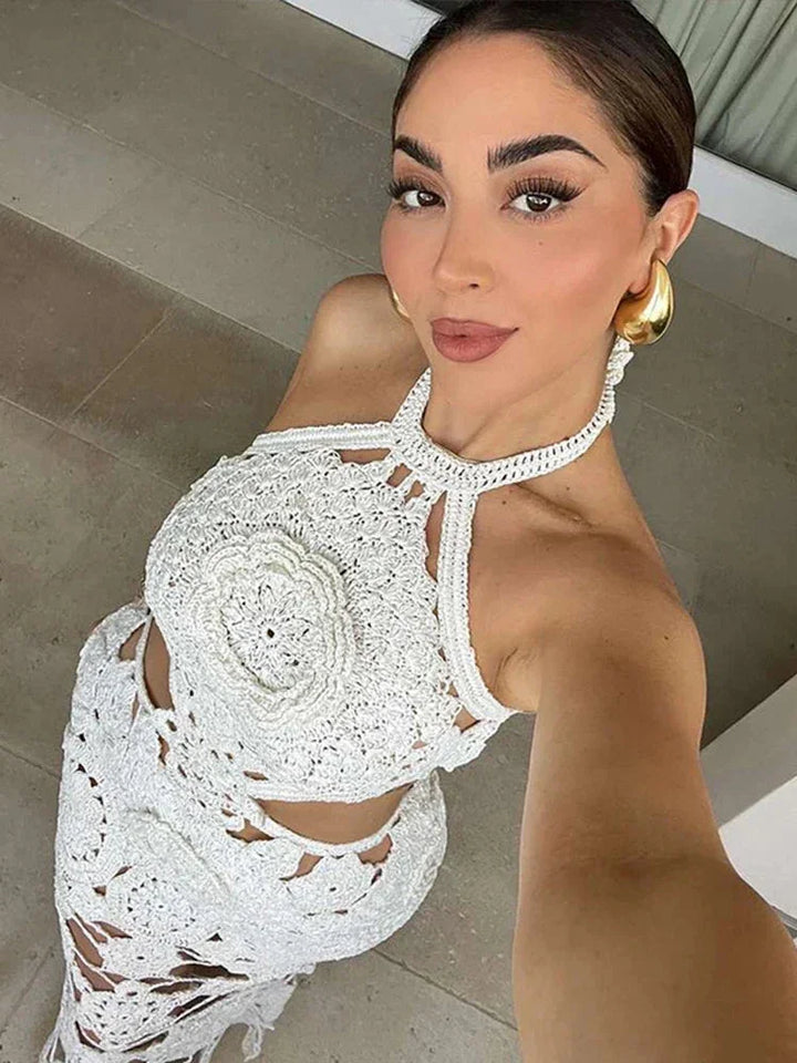 Sleeveless white crochet maxi dress by Kylani, featuring intricate crochet details and a flowing silhouette.