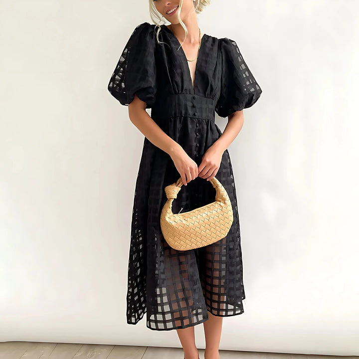 Black textured V-neck midi dress for women by Kyndal with a flattering silhouette and classy design.