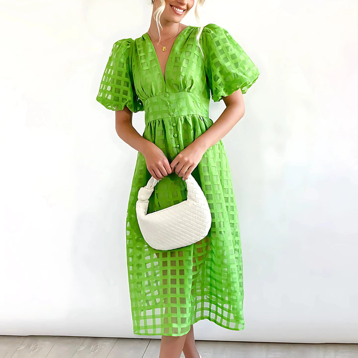 "Green V-neck midi dress in textured fabric for women by Kyndal, perfect for casual outings or special occasions."