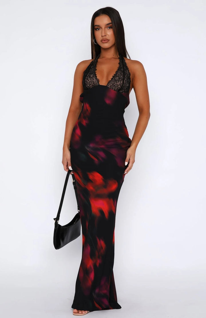 Black halter neck dress with delicate lace overlay on the bodice and a flowing skirt, perfect for a chic evening out.