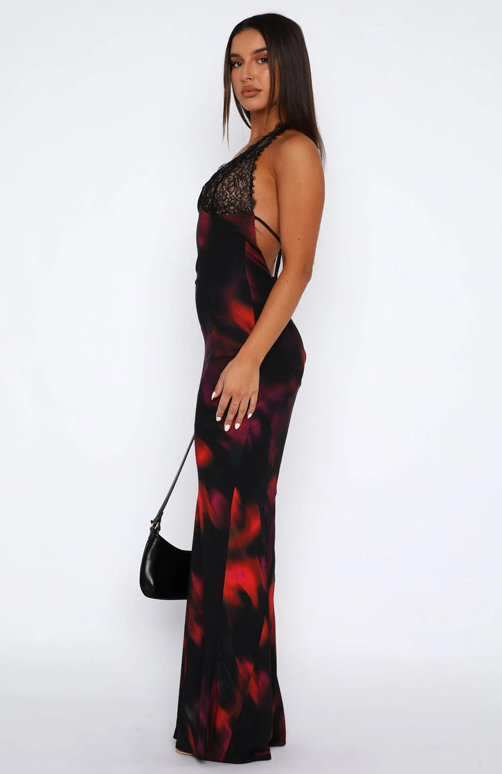 Black halter neck dress with intricate lace details at the waist and hem, crafted from a lightweight and breathable fabric.