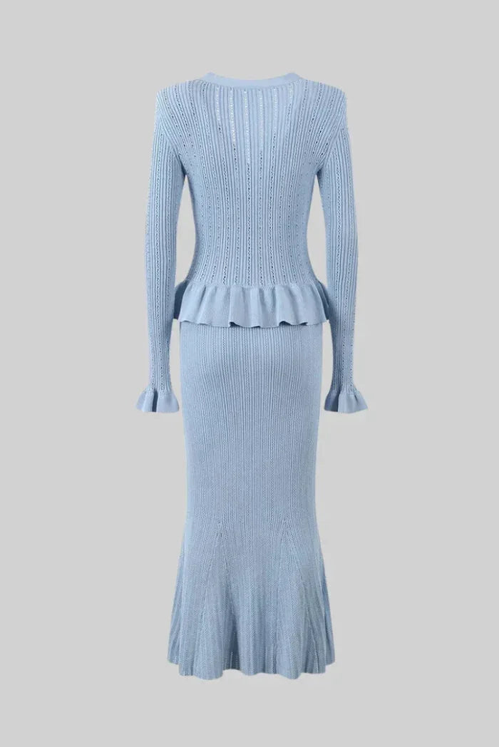 "Women's fitted knitwear ensemble in soft, stretchy fabric with ribbed texture, V-neckline, and matching slim pants in…