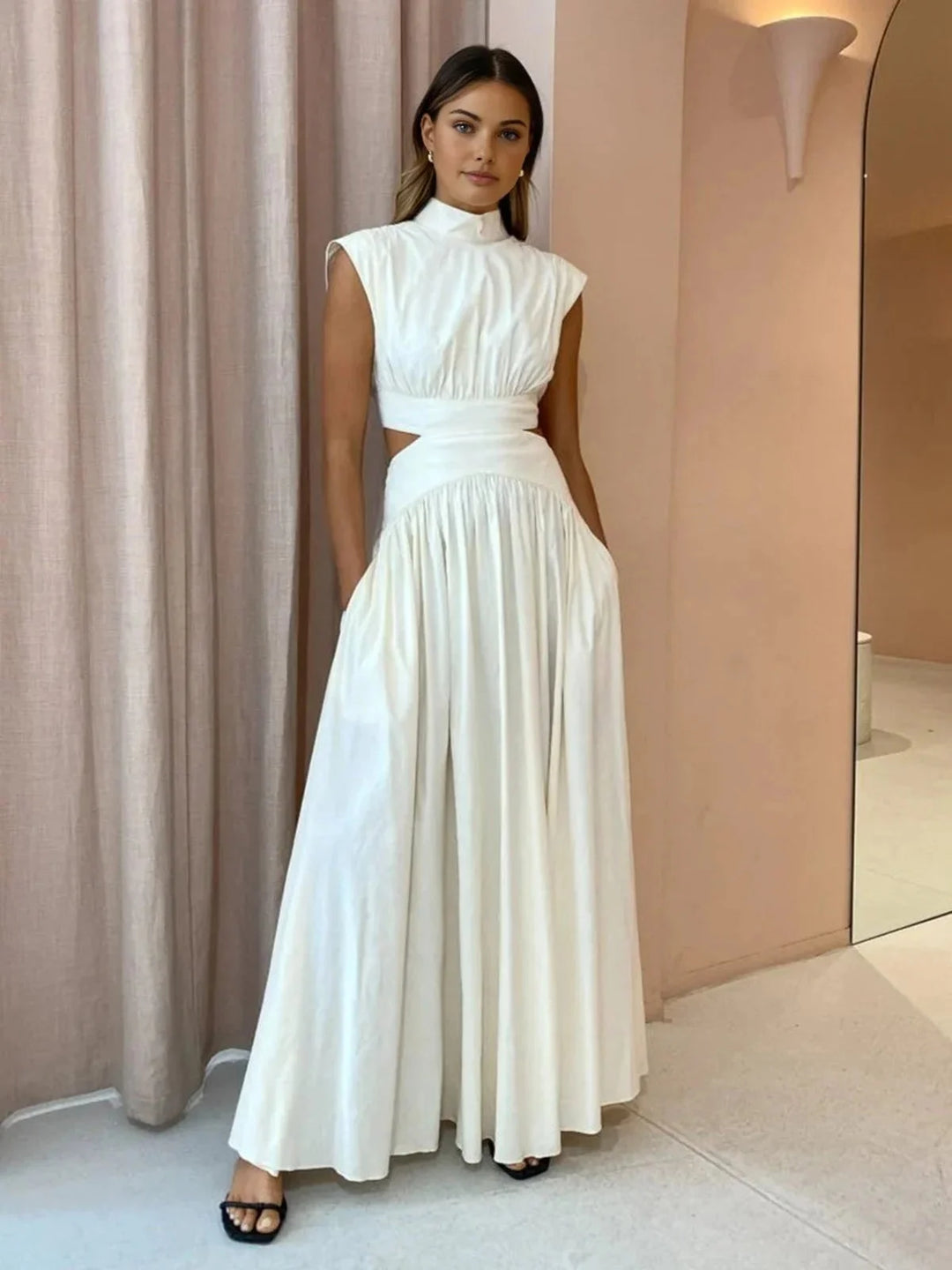 Sleeveless mock neck dress in a sleek design with cutouts, crafted from a stretchy and comfortable fabric.
