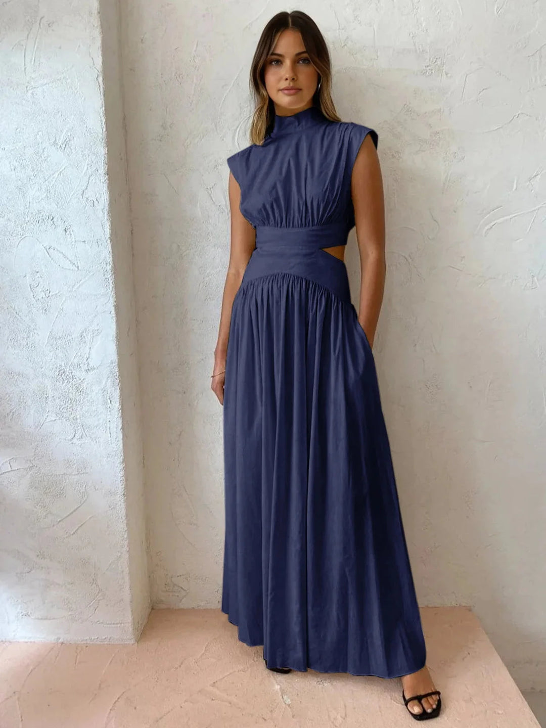 Sleek black sleeveless dress with mock neck and chest cutouts, perfect for a modern and stylish look.