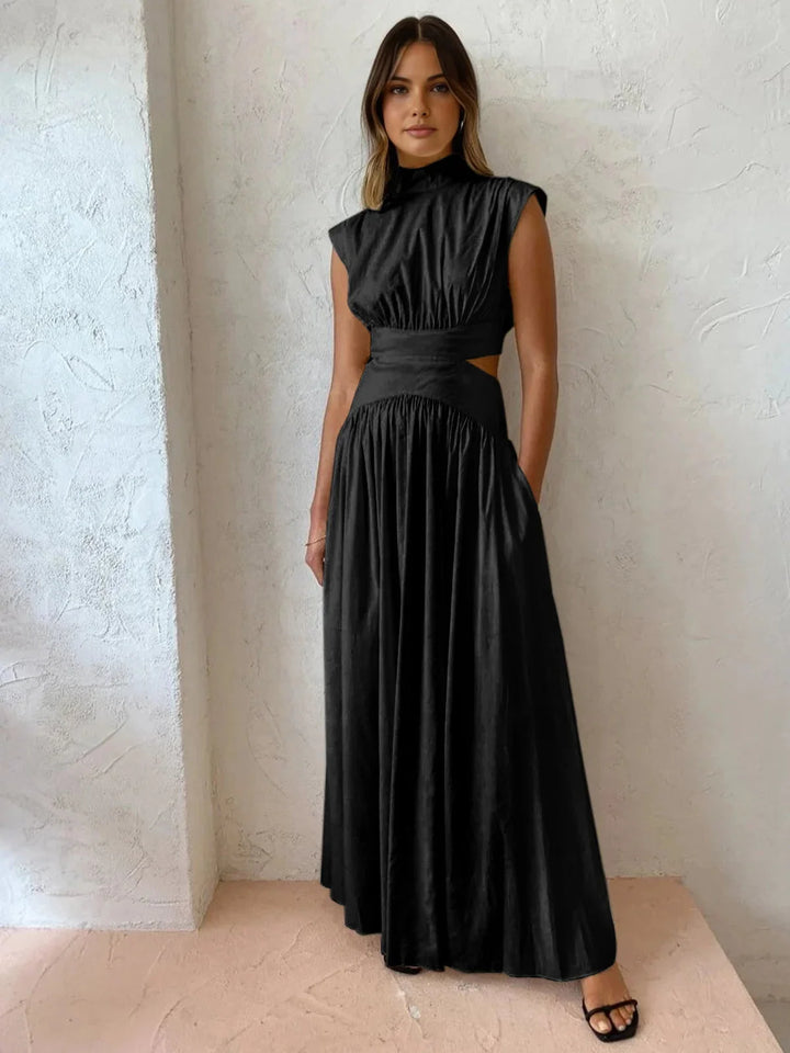 "Sleek black sleeveless dress with high mock neck and edgy cutouts, perfect for a chic and modern look."