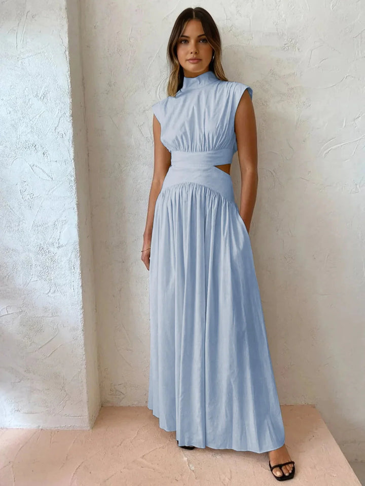 Light Blue sleeveless dress with mock neck and cutouts. Made with soft, breathable fabric, ideal for a casual yet stylish…