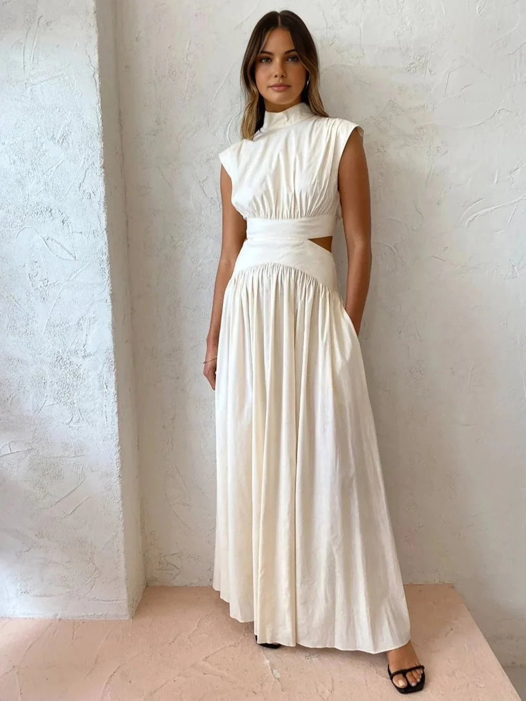 White sleeveless dress with mock neck and cutouts, perfect for special occasions. Made with soft and breathable fabric for a…