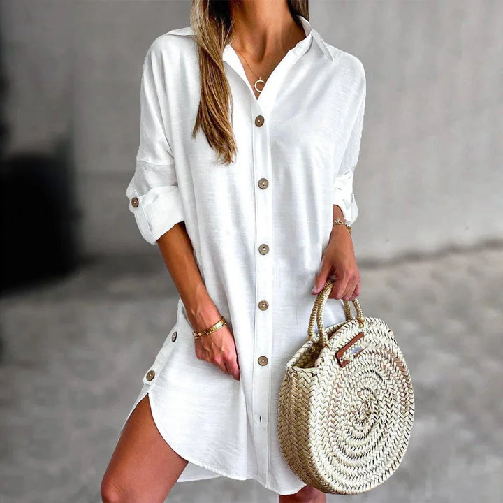 Alt text: "Black mini dress with button details, V-neckline, and tie waist; perfect for a chic and stylish look on any…
