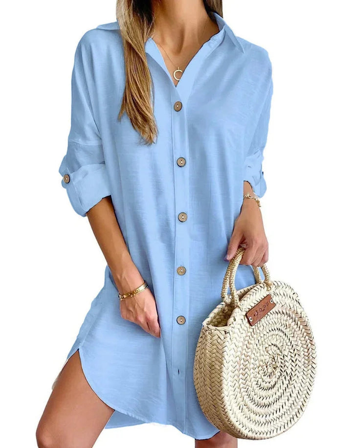 Light blue mini dress with button details for a chic look. Features a comfortable fabric with a stylish and elegant design.