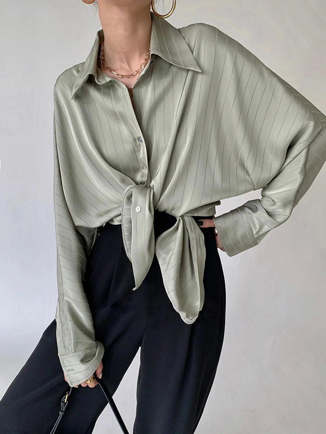 Sleek button-up shirt in Laylani with striking gold accents, made of soft cotton blend, perfect for everyday wear or a…