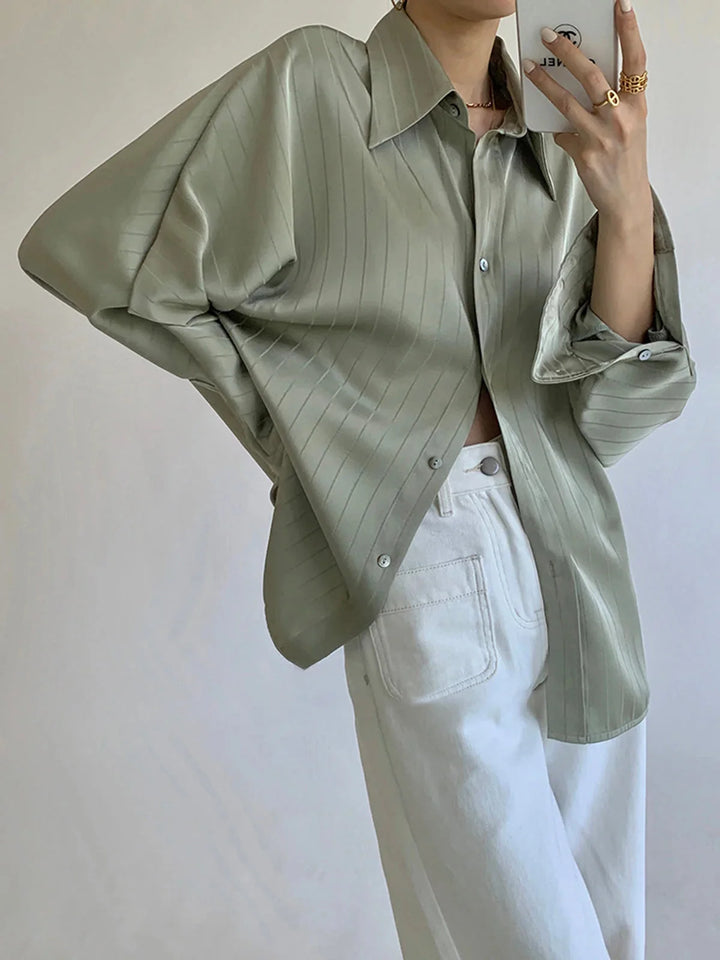 Green Laylani button-up shirt with elegant gold accents, crafted from a soft and lightweight fabric with a slim fit design.