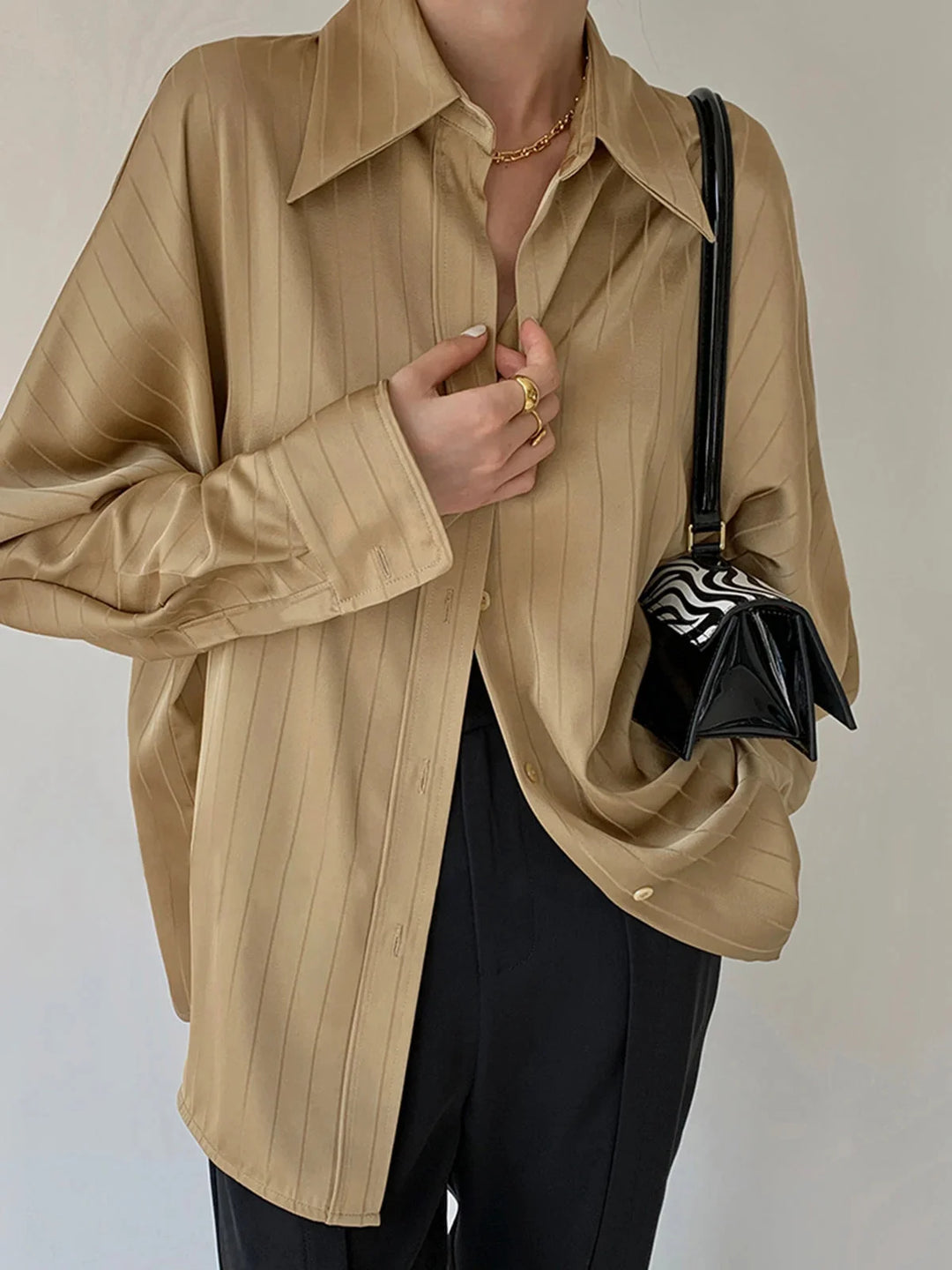 Yellow Laylani button-up shirt with gold detailing, made from soft cotton blend. Sleek design with unique gold accents.
