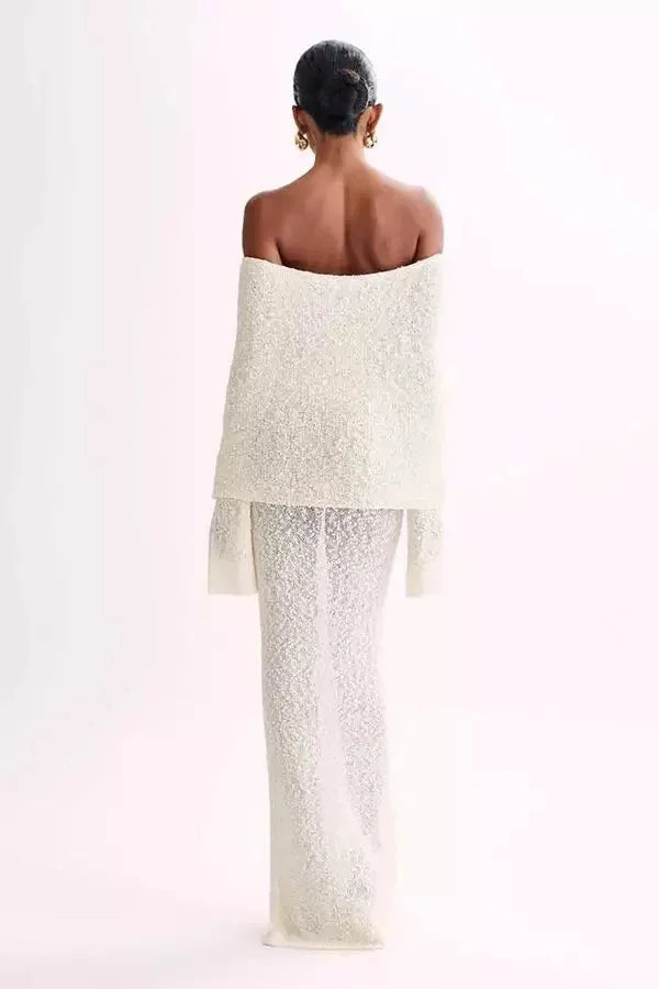 Off-shoulder dress featuring elegant sleeves, made from soft, flowy fabric.