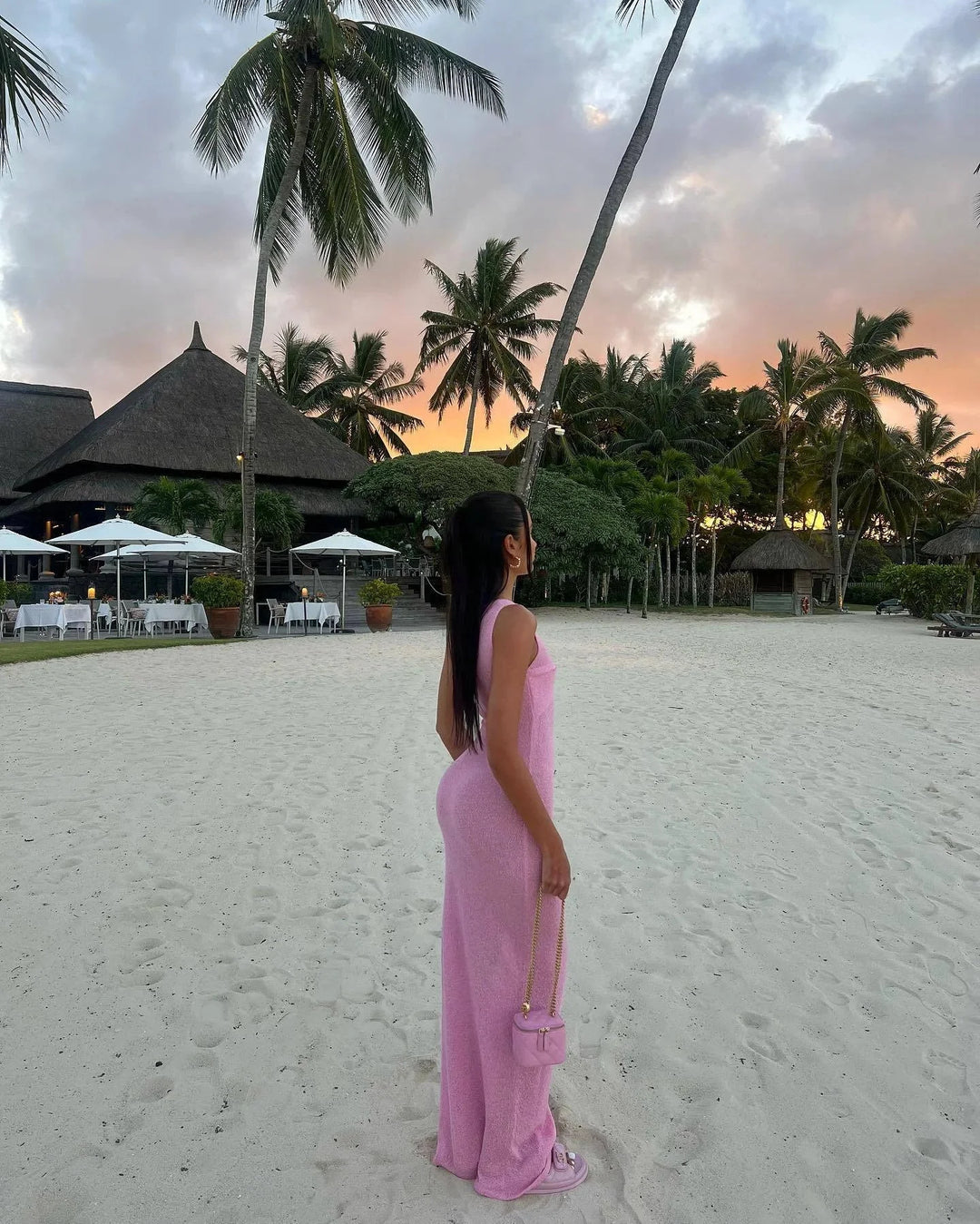 "Sleeveless maxi dress with twist detail, made from breathable fabric, perfect for warm days."