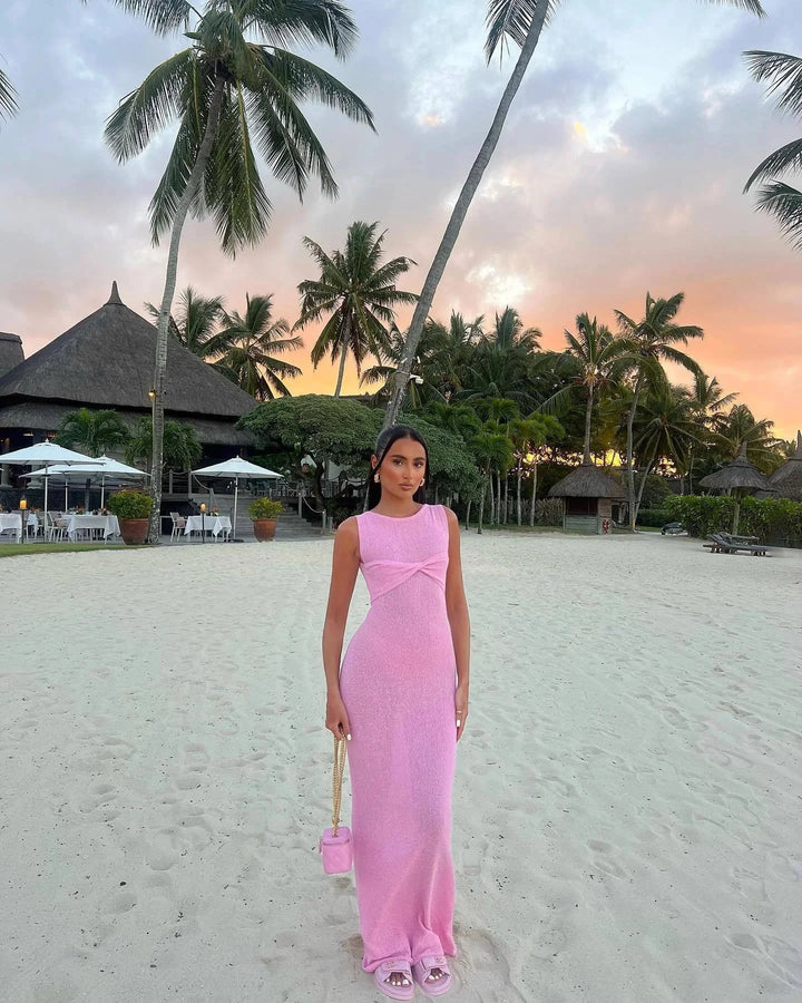 "Sleeveless maxi dress in Pink with twist detail, made of lightweight fabric. Perfect for a chic and stylish look."