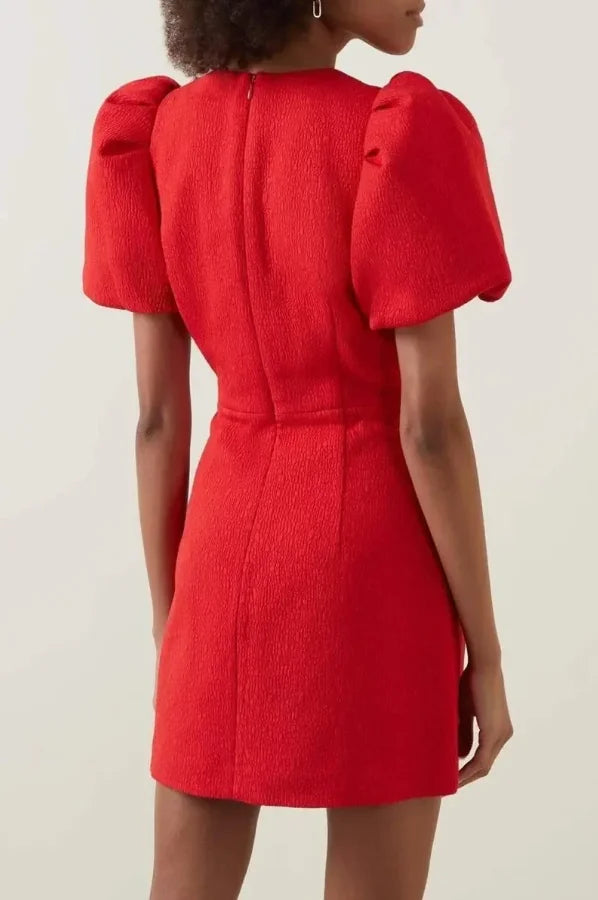 Red mini dress with heart cutouts and puffy sleeves, made of lightweight fabric, perfect for a fun and flirty look.
