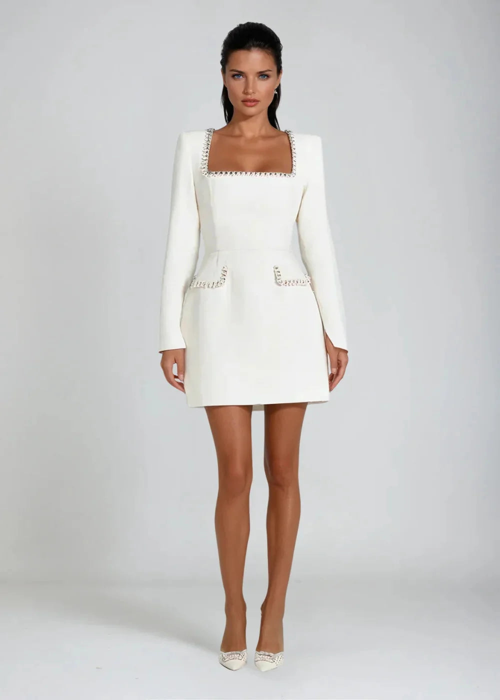 White square neckline mini dress with bead details, perfect for a chic look. Crafted in high-quality fabric, this dress…