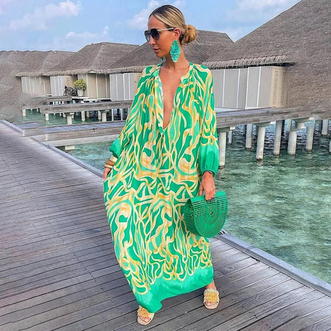 Green chiffon beach kaftan dress with breezy design, perfect for sunny days by the water.