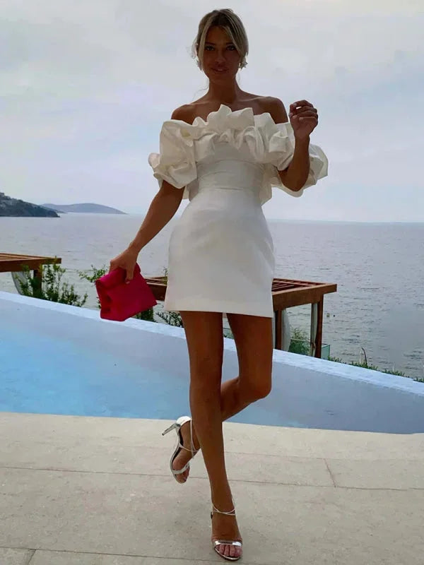 "Black off-shoulder dress with ruffles, form-fitting silhouette, perfect for a stylish evening look"