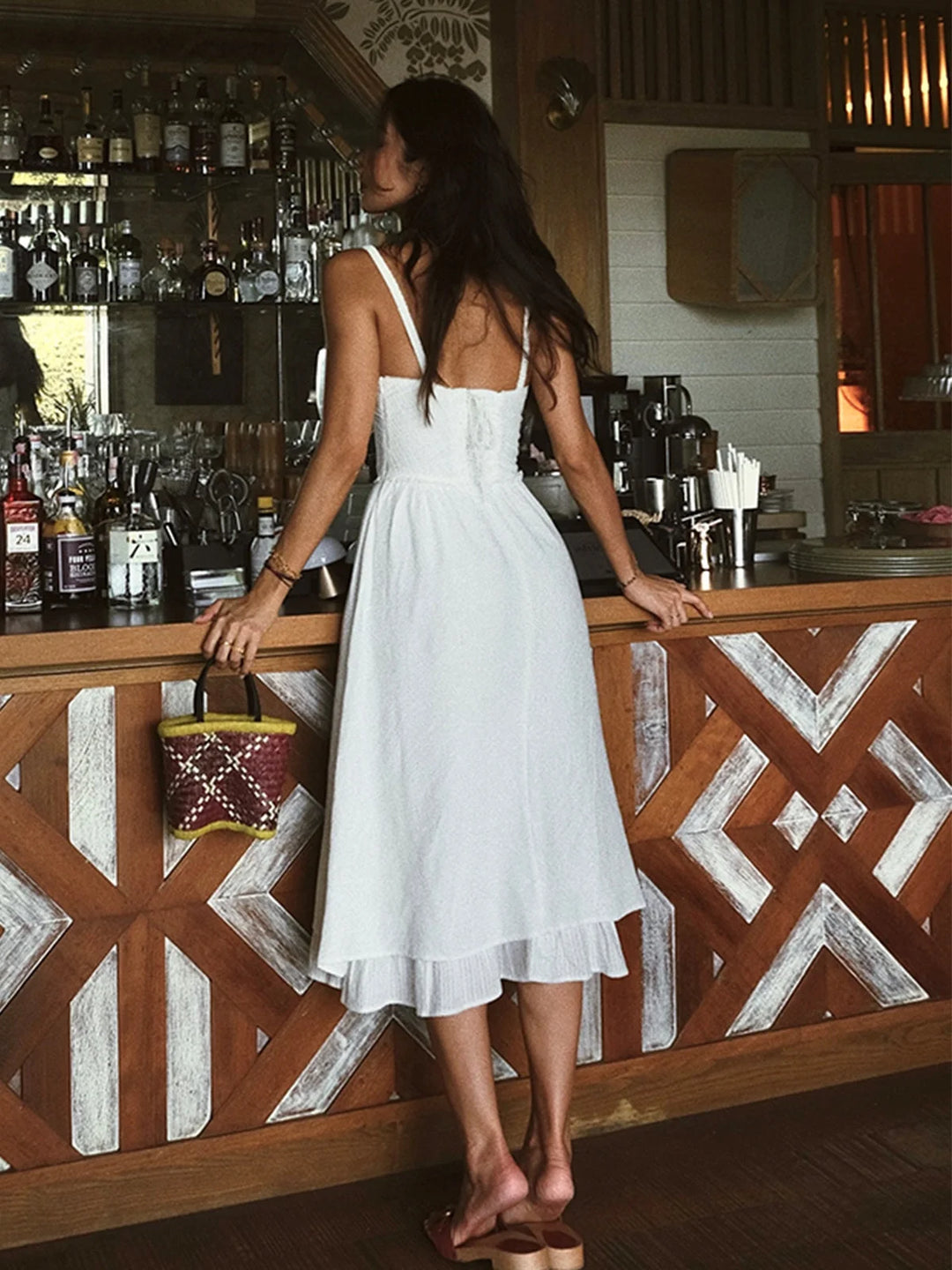 "Women's tiered midi dress in a textured fabric with ruching details, ideal for casual and special occasions."