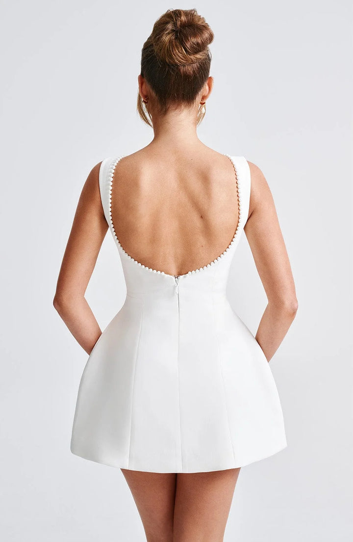 Black backless dress adorned with delicate pearl accents on the back, perfect for a sophisticated evening look.
