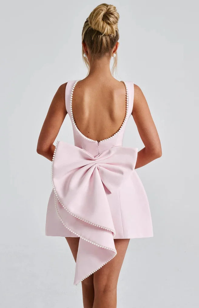 Black backless dress with pearl embellishments, showcasing a sleek and elegant design perfect for special occasions.