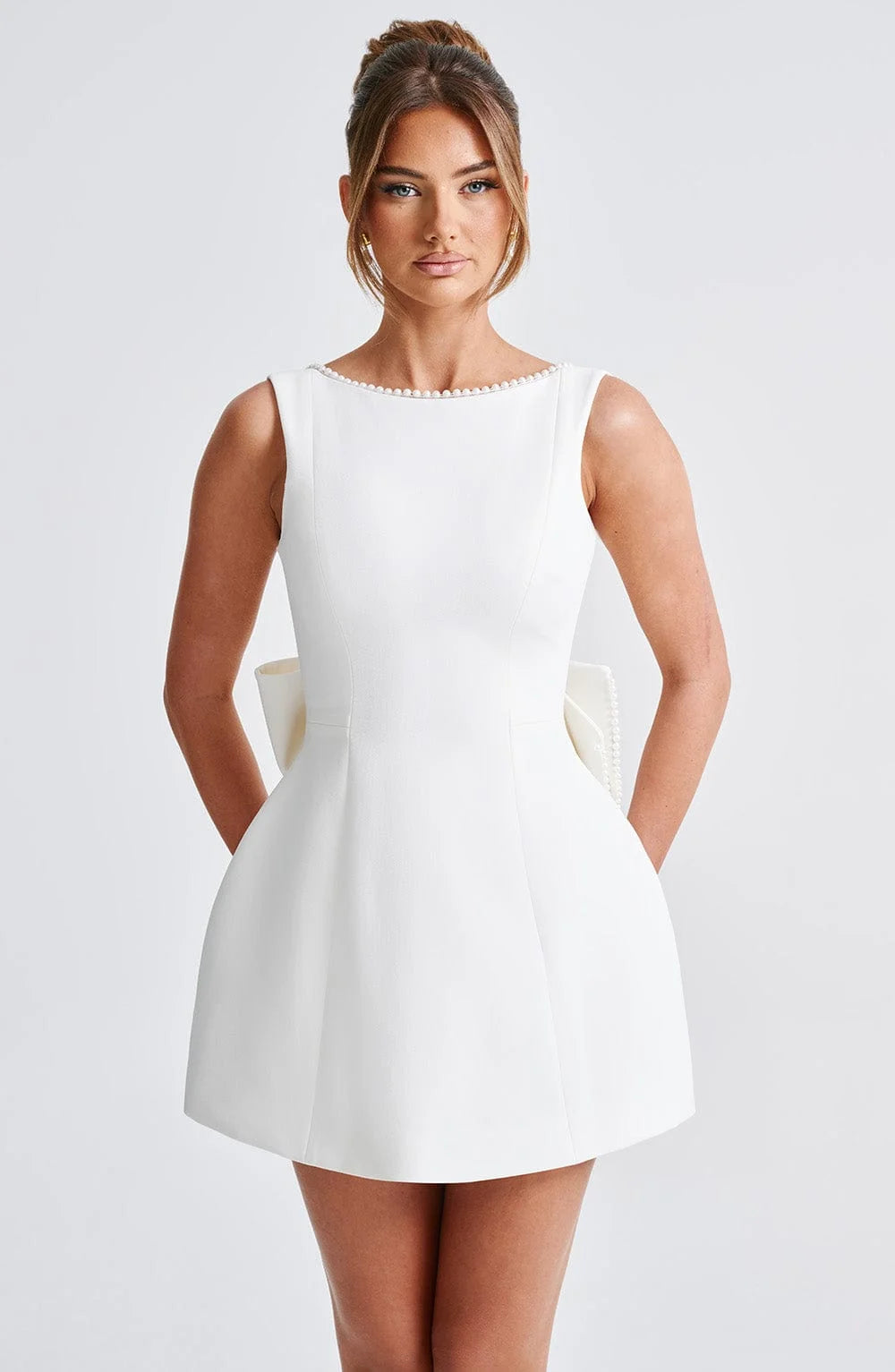 "Black backless dress adorned with elegant pearl accents - perfect for a sophisticated evening look."