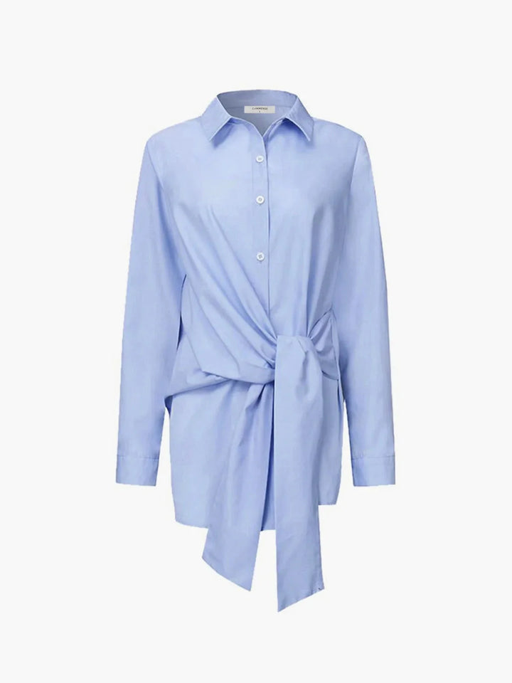 Blue adjustable front-tie blouse with buttoned cuffs. Made of a soft and flowy material, with a flattering fit for stylish…