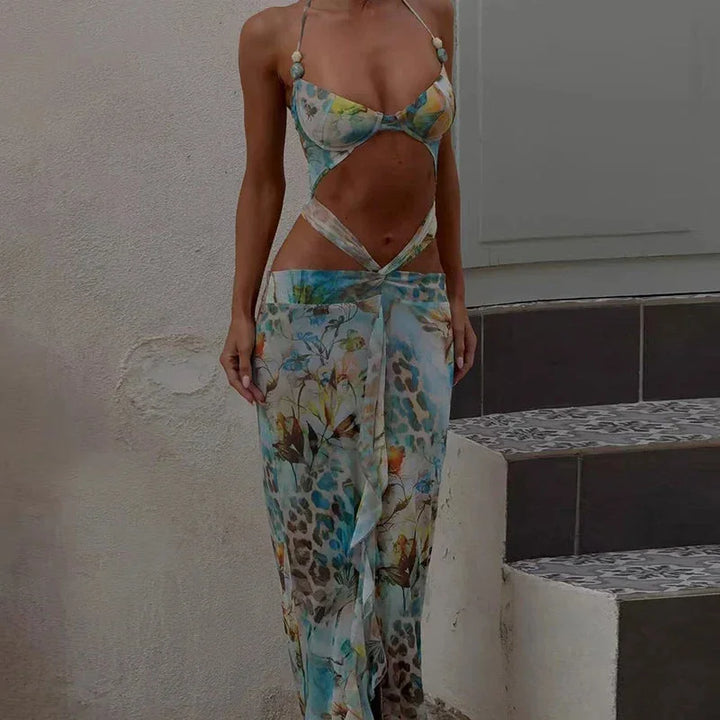 "Turquoise floral maxi dress with vibrant colors and elegant design, perfect for a stylish and feminine look."