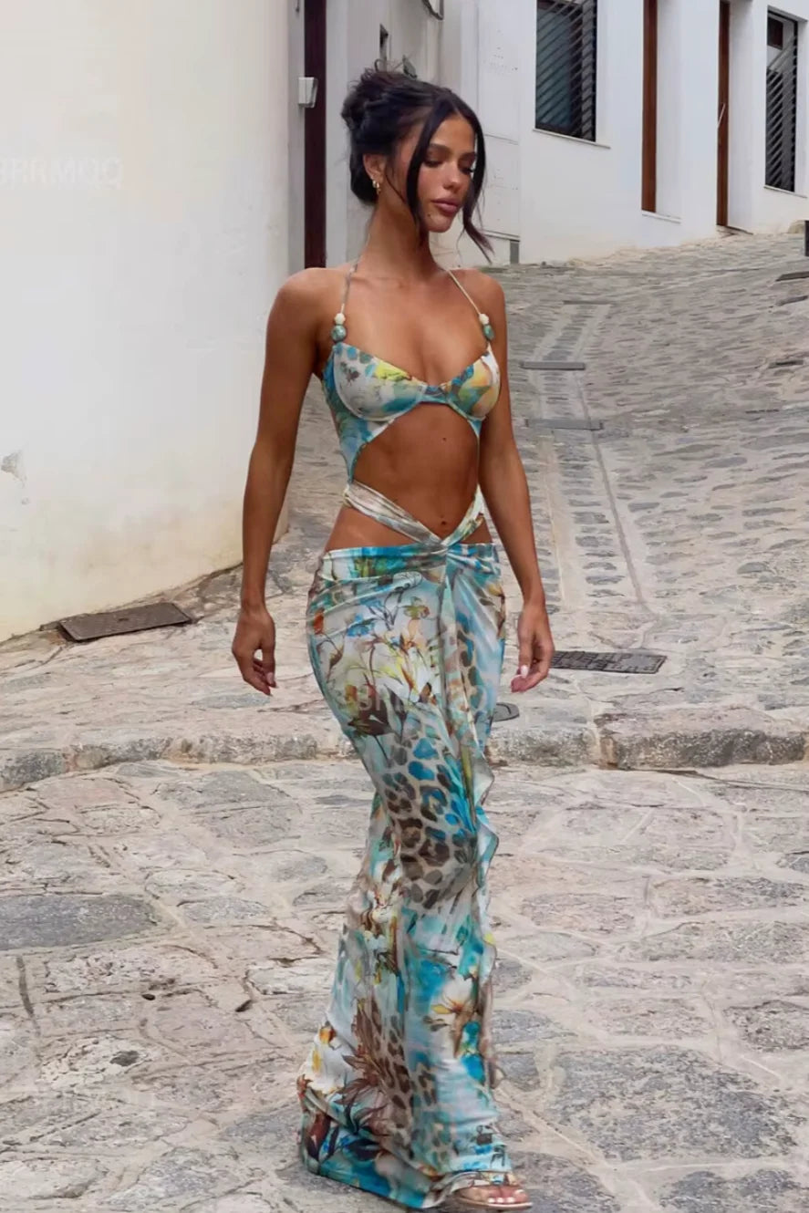 Turquoise floral maxi dress with vibrant design, perfect for any occasion.