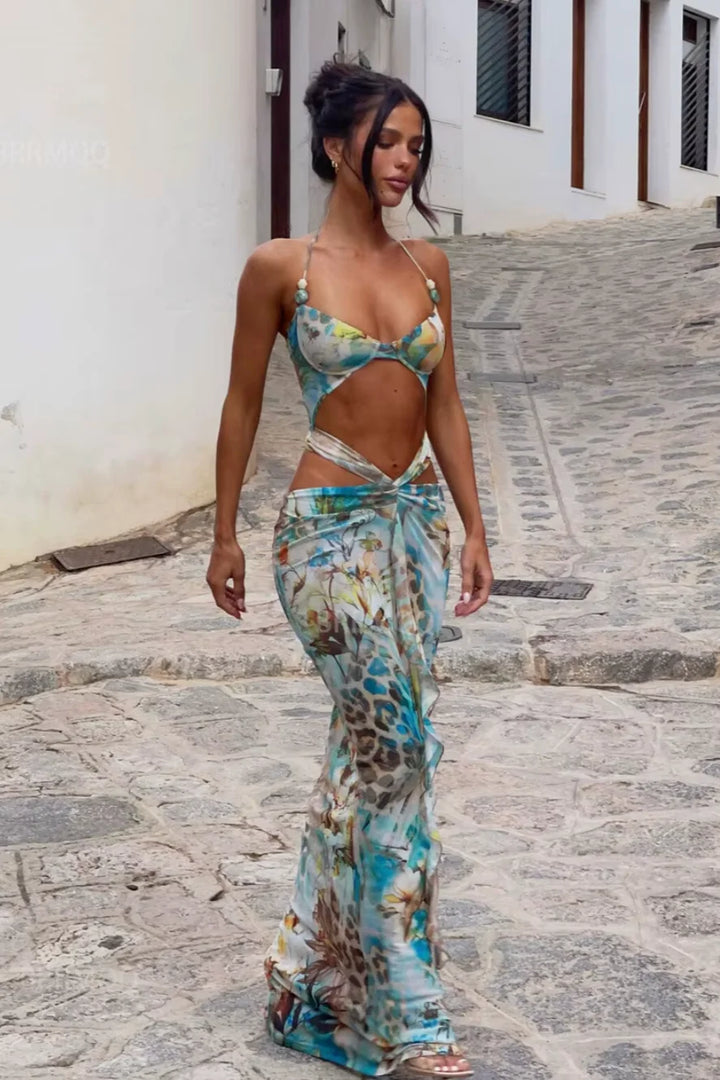 Turquoise floral maxi dress with vibrant design, perfect for any occasion.