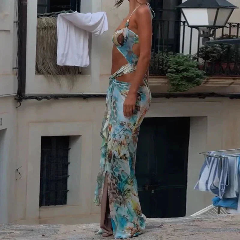 Vibrant turquoise floral maxi dress with a flowy silhouette and adjustable straps, perfect for a summer day out.