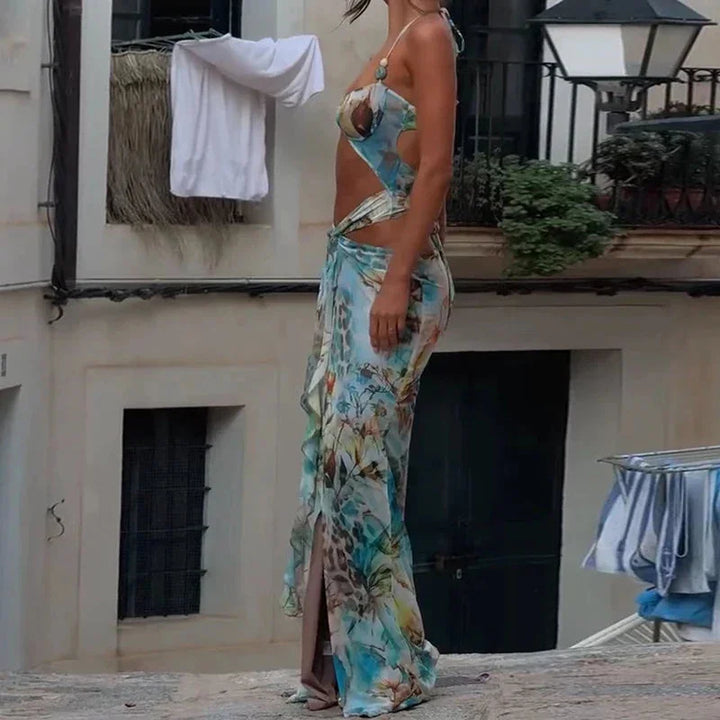 Vibrant turquoise floral maxi dress with a flowy silhouette and adjustable straps, perfect for a summer day out.