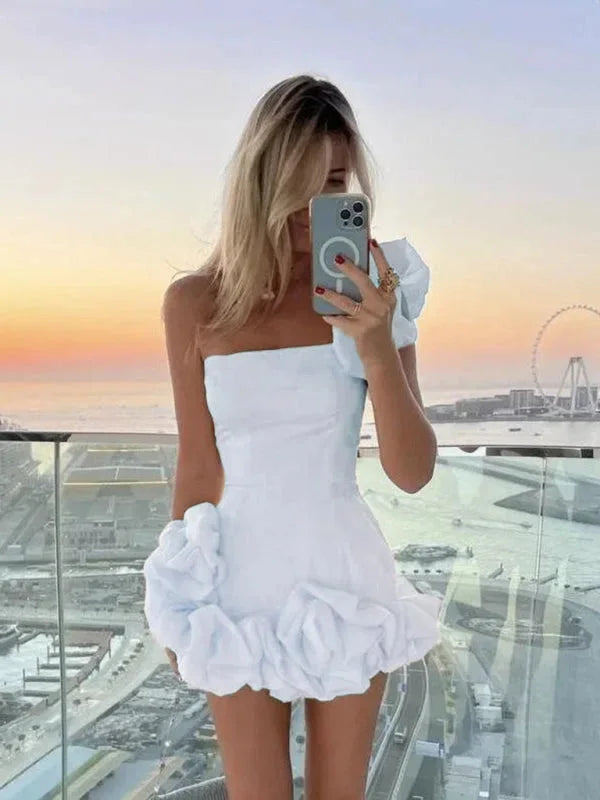 Off-shoulder white mini dress with stylish asymmetrical ruffles, ideal for summer gatherings or casual outings.