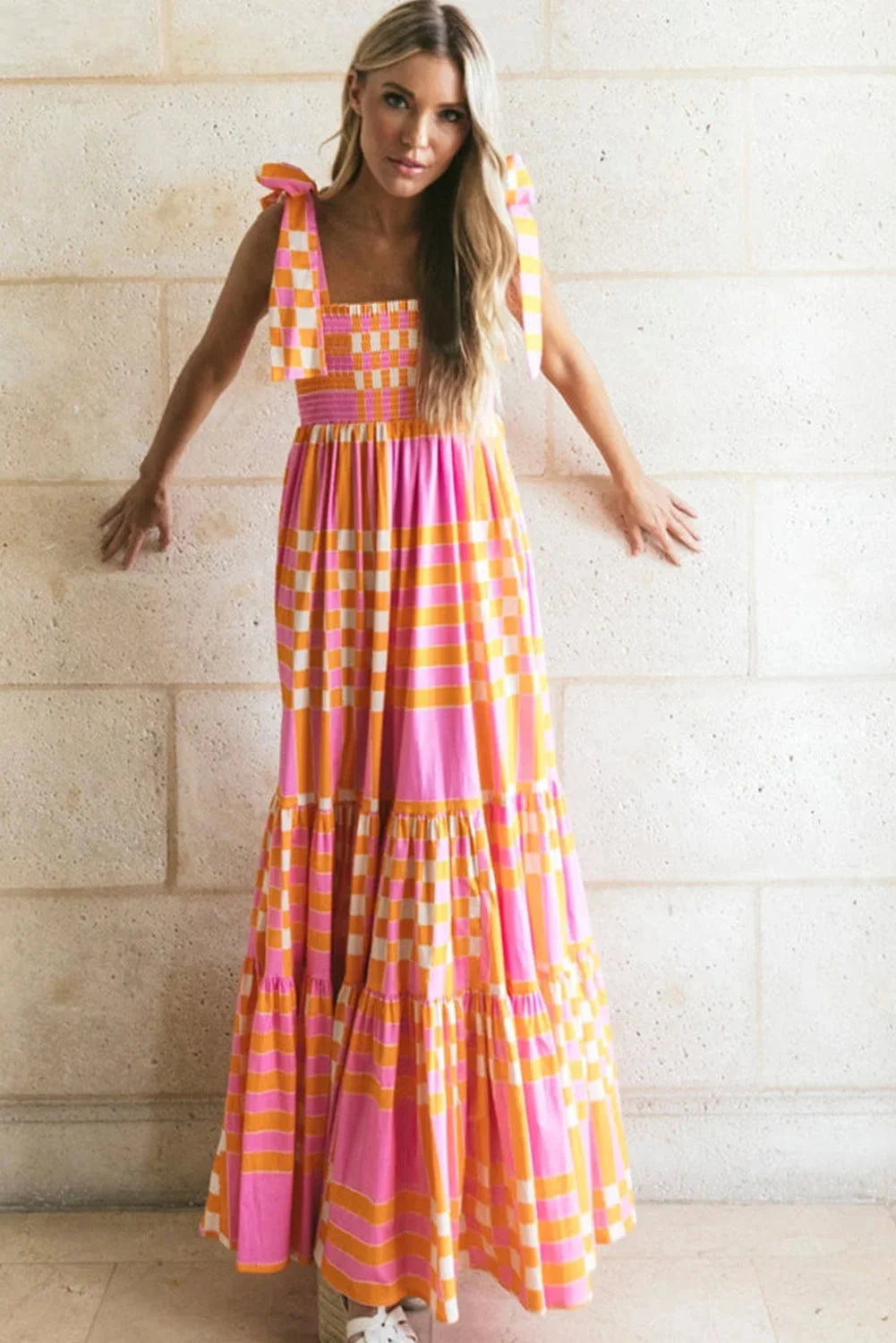 "Black and white smocked maxi dress with checkered pattern, perfect for summer outings with a breezy and elegant design."