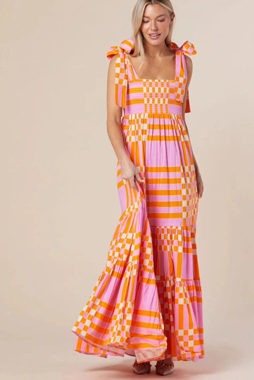 "Madelyne smocked maxi dress with checkered design, featuring soft cotton fabric and elegant gathers at the waist."