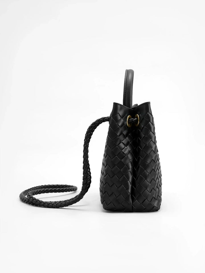 Mahina tote bag with intricate weave design and metal details, showcasing elegance and craftsmanship in a unique accessory.