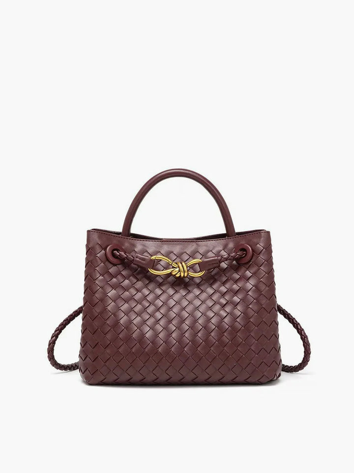 Maroon tote bag with detailed weaving and metal accents, perfect for adding a touch of elegance to any outfit.