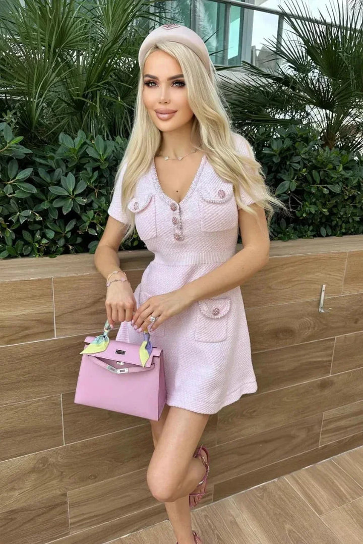 Pink short dress with buttons and pockets, made from soft and breathable fabric, perfect for a casual and comfortable summer…