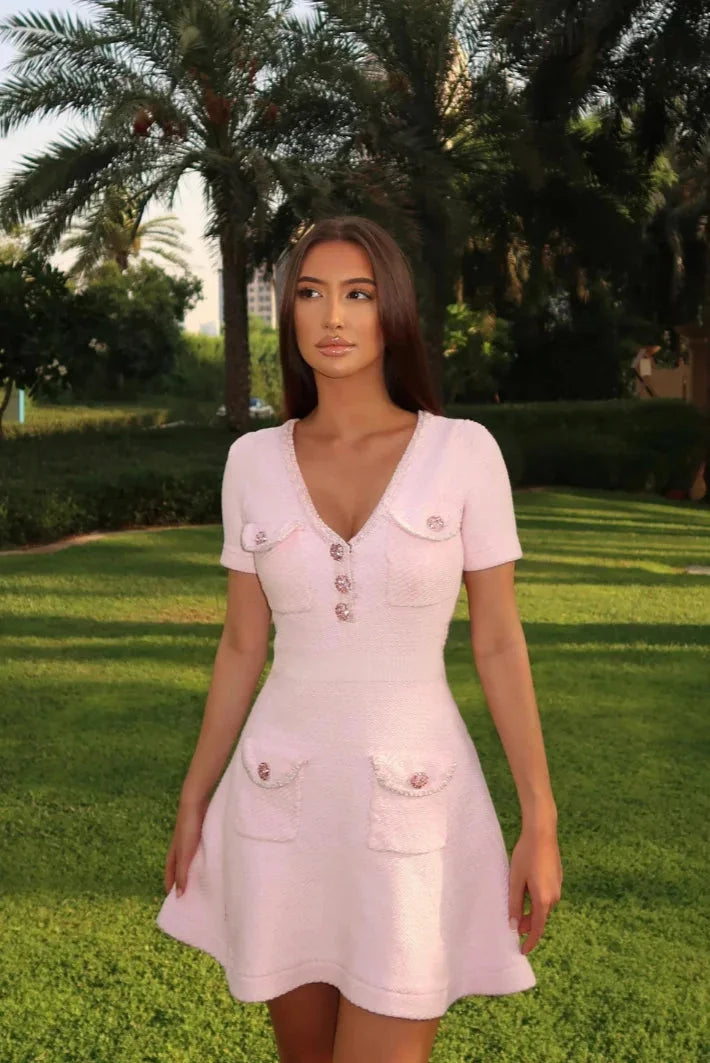Pink short dress with button detail and pockets, made of soft cotton. Casual and stylish wardrobe essential for everyday…