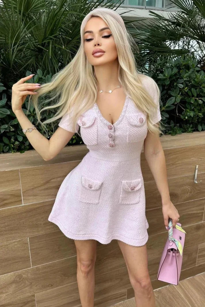Pink short dress with buttons and pockets made of soft cotton blend fabric, casual and stylish for everyday wear.