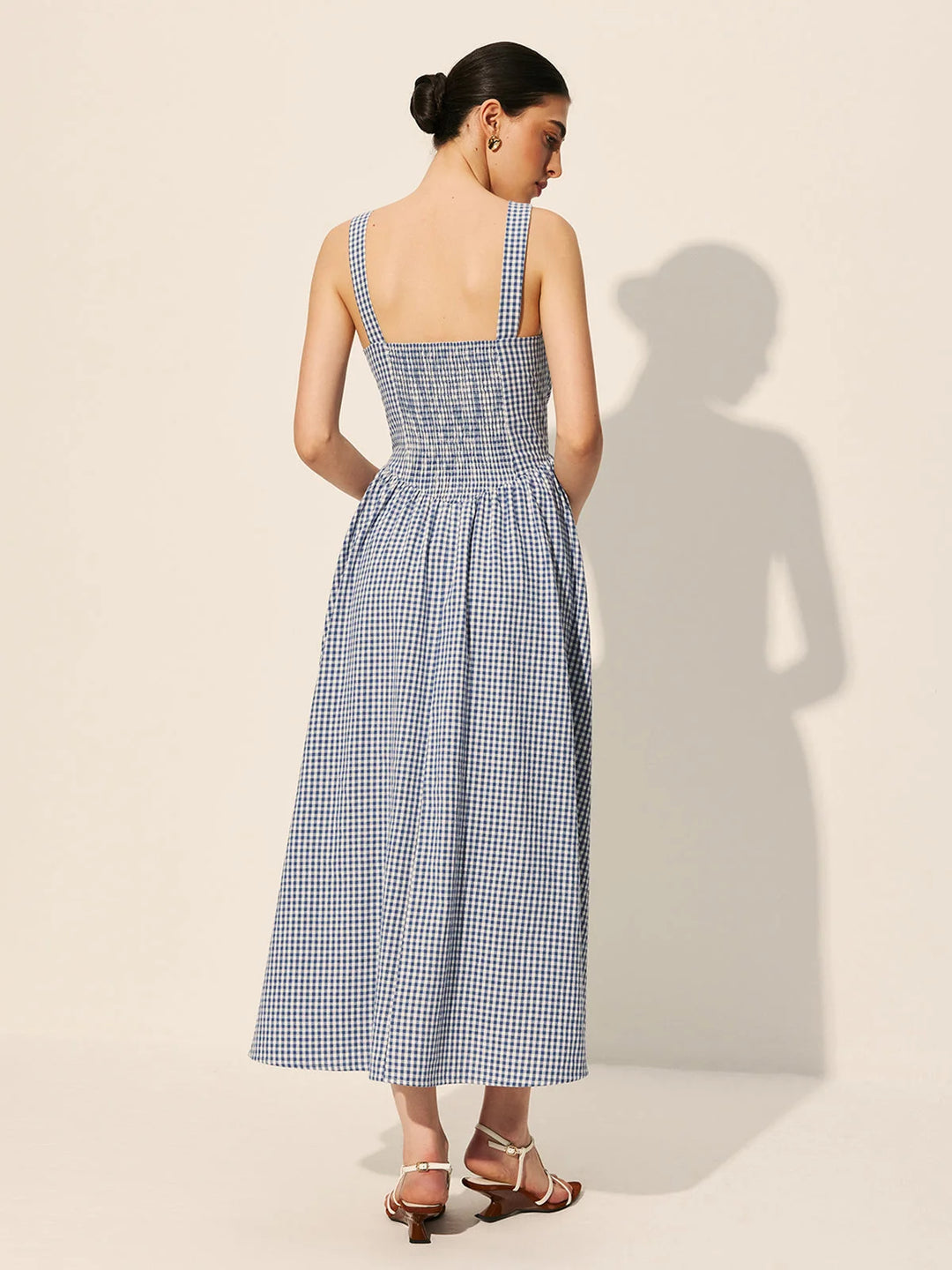 "Sleeveless navy gingham maxi dress made of lightweight cotton, perfect for a casual summer look."